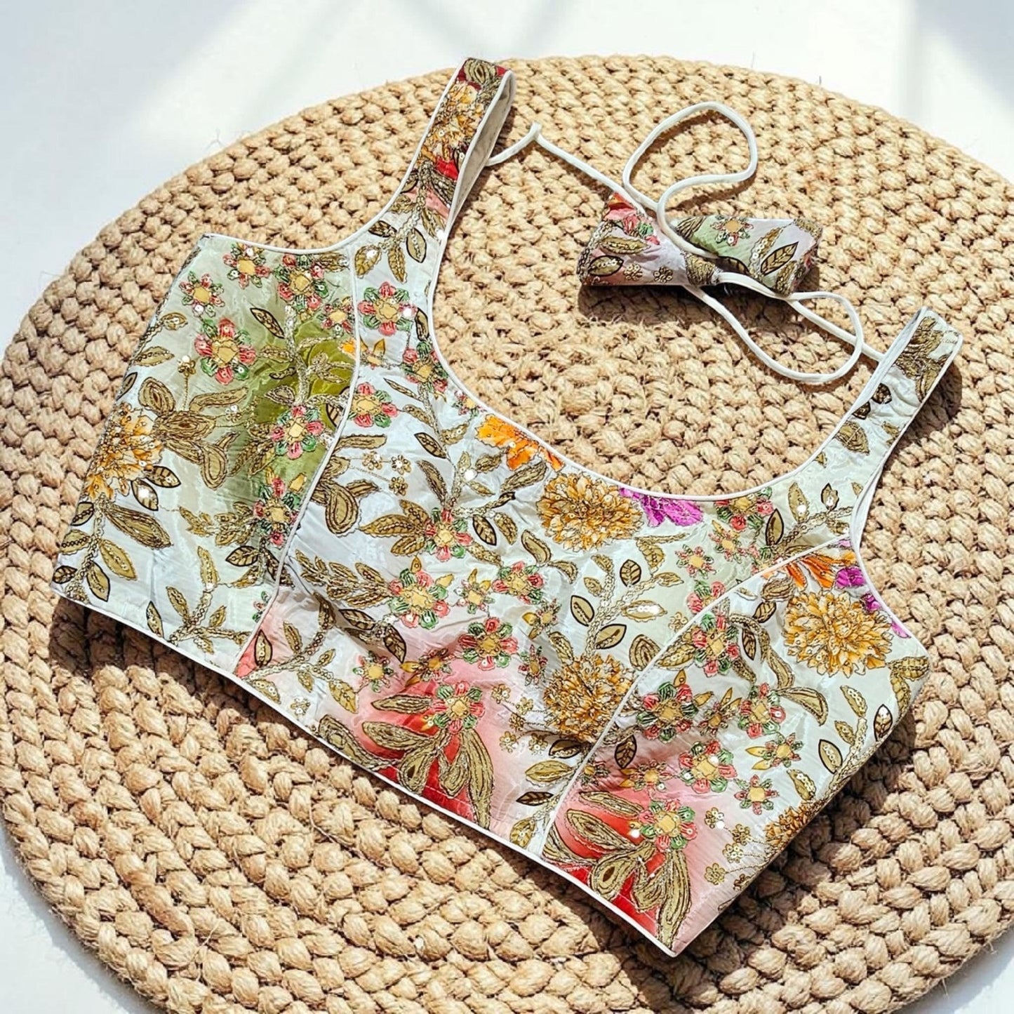 Manishaa's Boutique sleeveless floral print padded saree blouse with gold embroidery and sequin details.