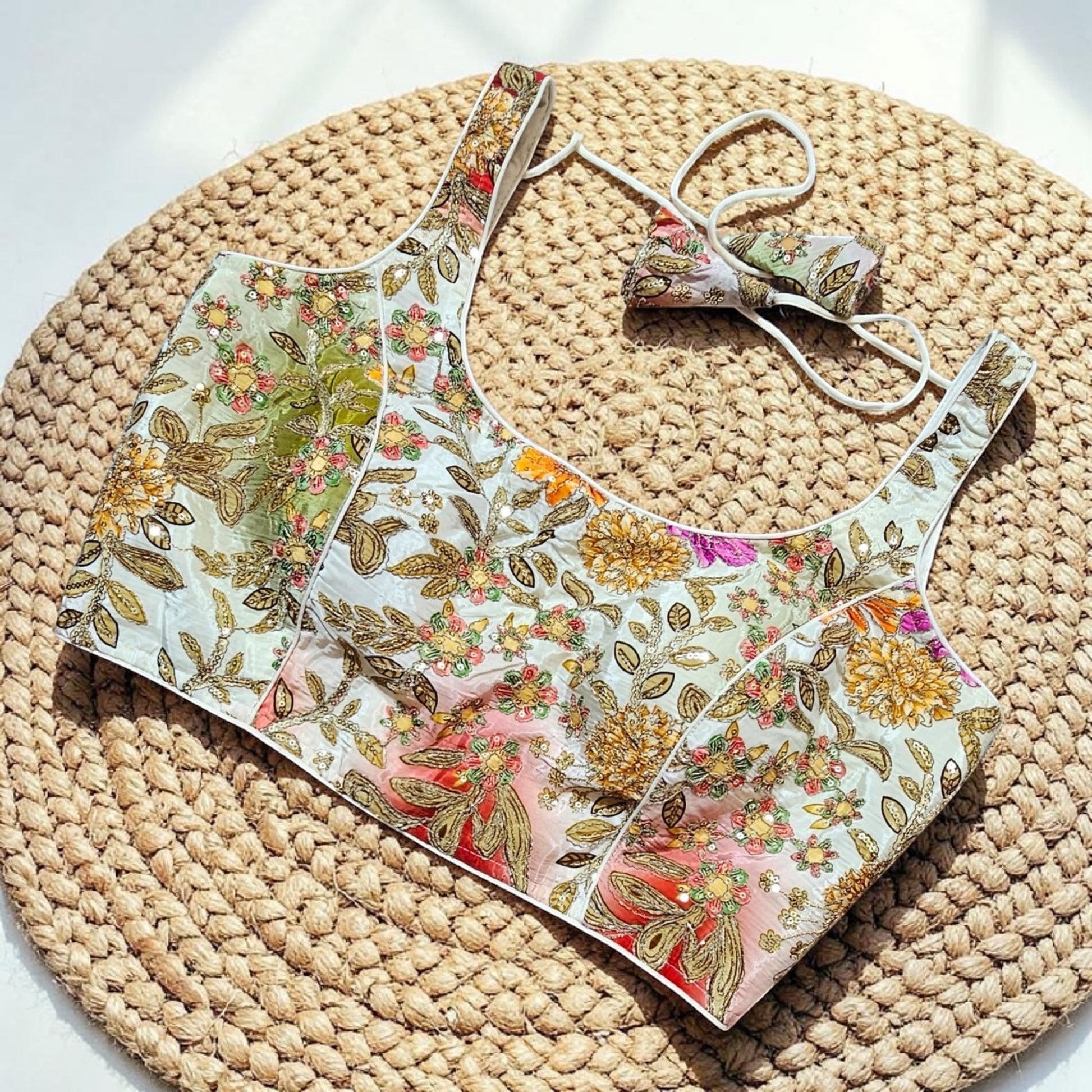 Manishaa's Boutique sleeveless floral print padded saree blouse with gold embroidery and sequin details.