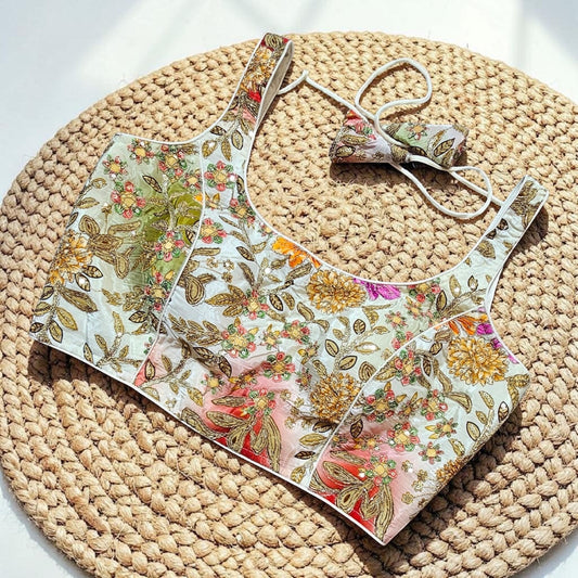 Manishaa's Boutique sleeveless floral print padded saree blouse with gold embroidery and sequin details.