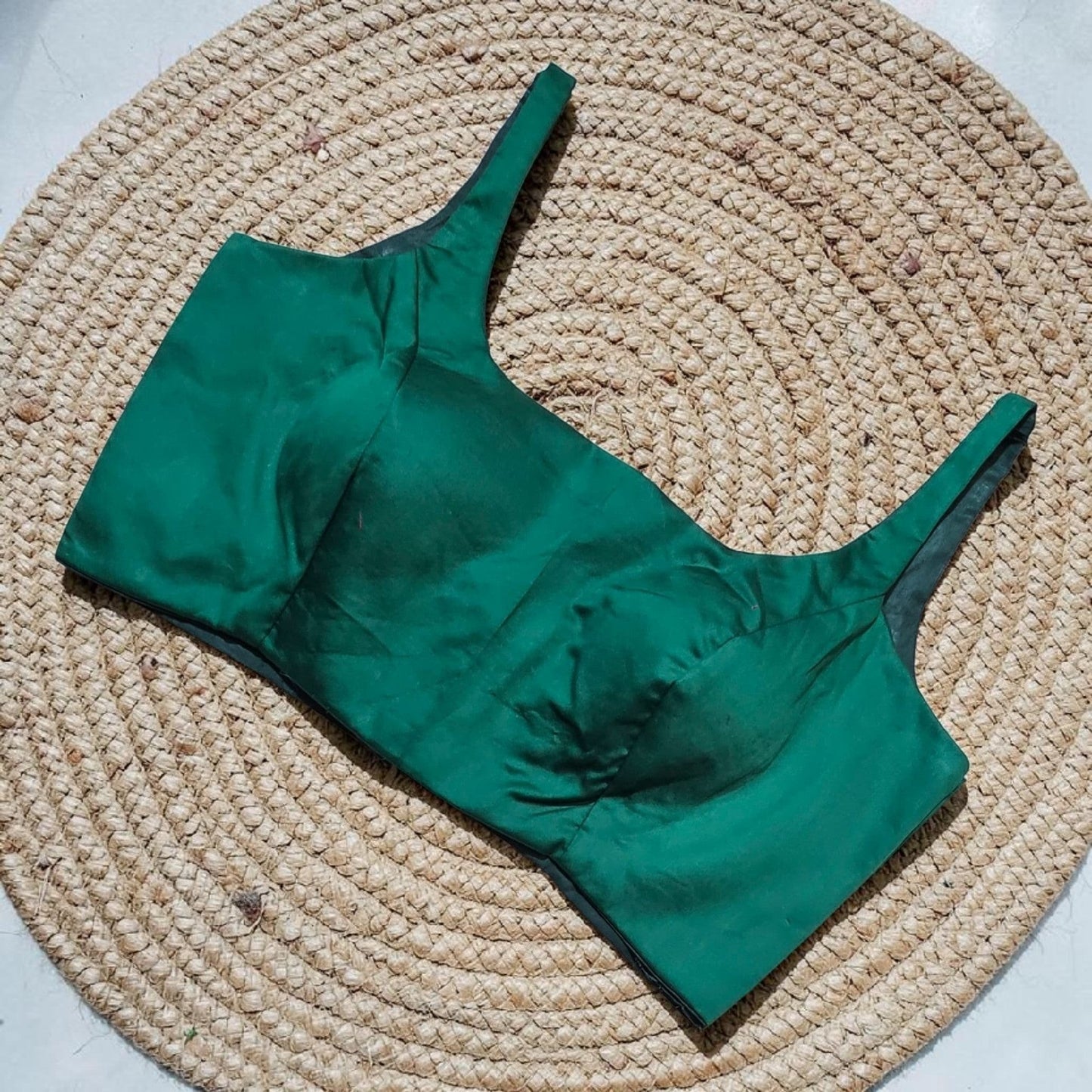 Manishaa's Boutique emerald green sleeveless readymade saree blouse with padded cups and back tie-up. Elite cut front neck.