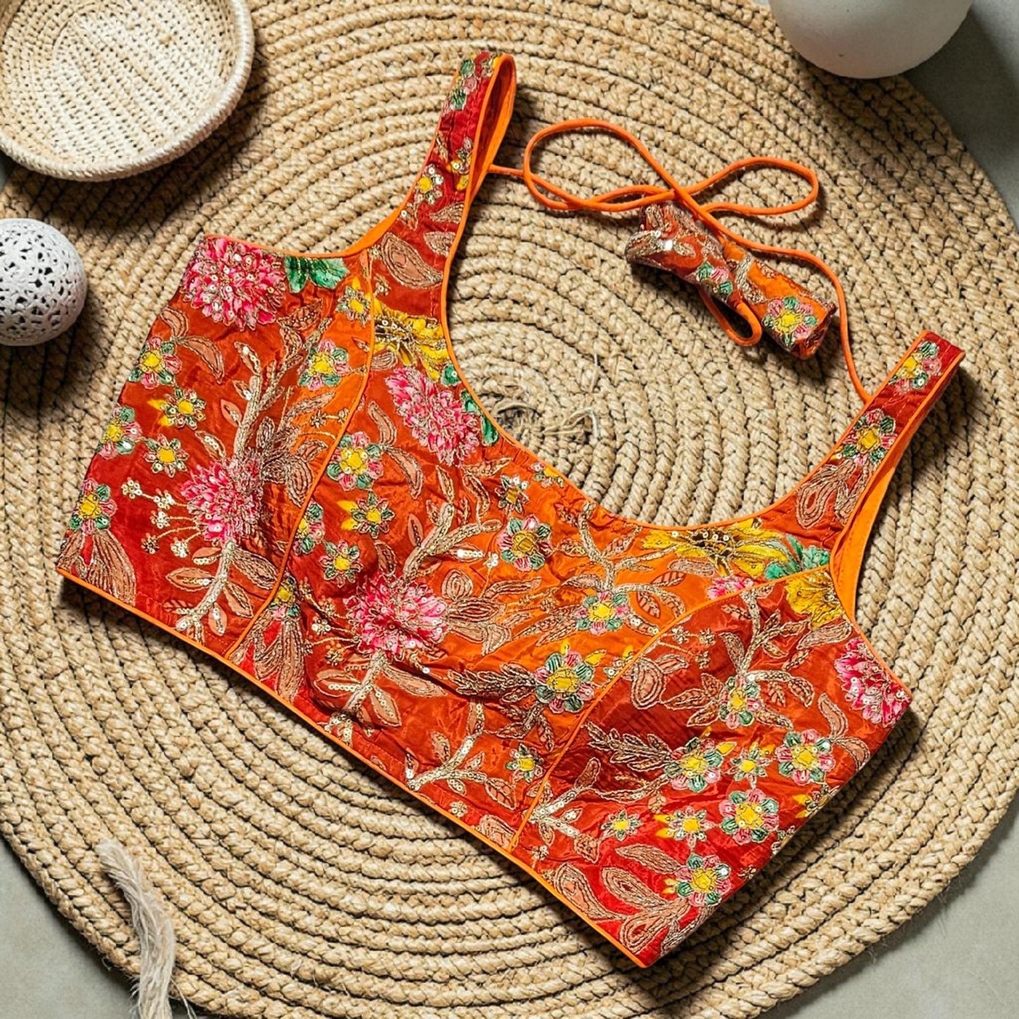 Manishaa's Boutique orange floral embroidered sleeveless padded saree blouse with tie-up detail. Sizes 36-46.