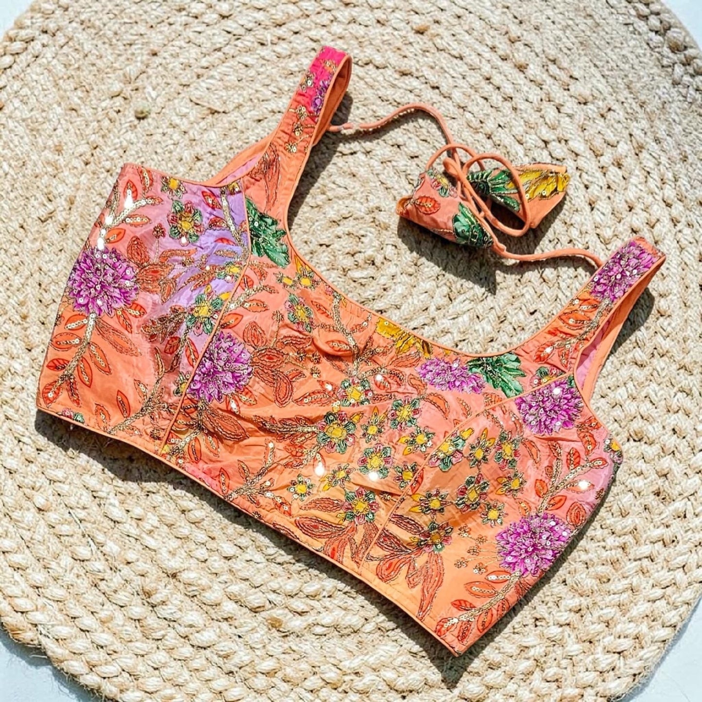 Manishaa's Boutique orange floral embroidered padded sleeveless saree blouse with sequin details.
