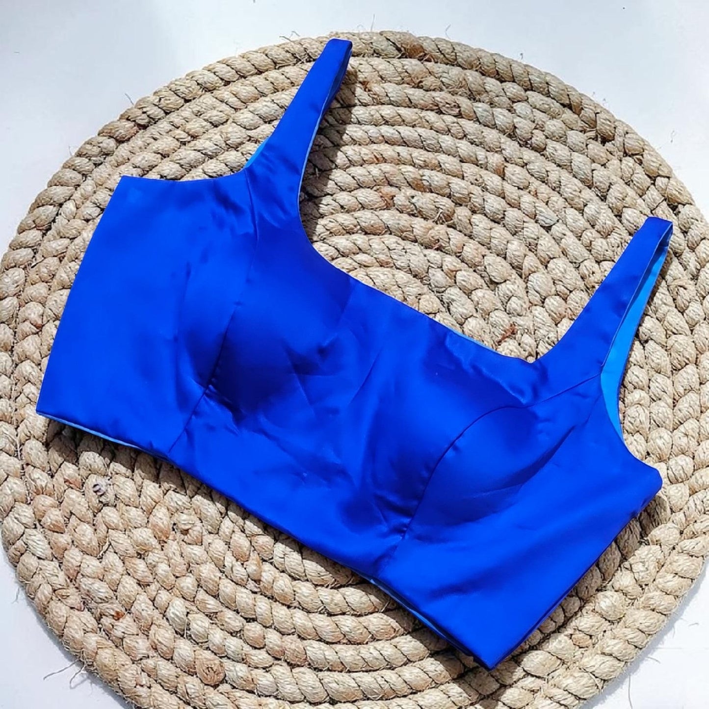 Manishaa's Boutique royal blue satin sleeveless readymade saree blouse with padded cups and a square neckline.